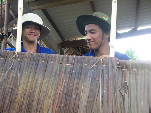 vietnamese hiding in a hut wearing a hat