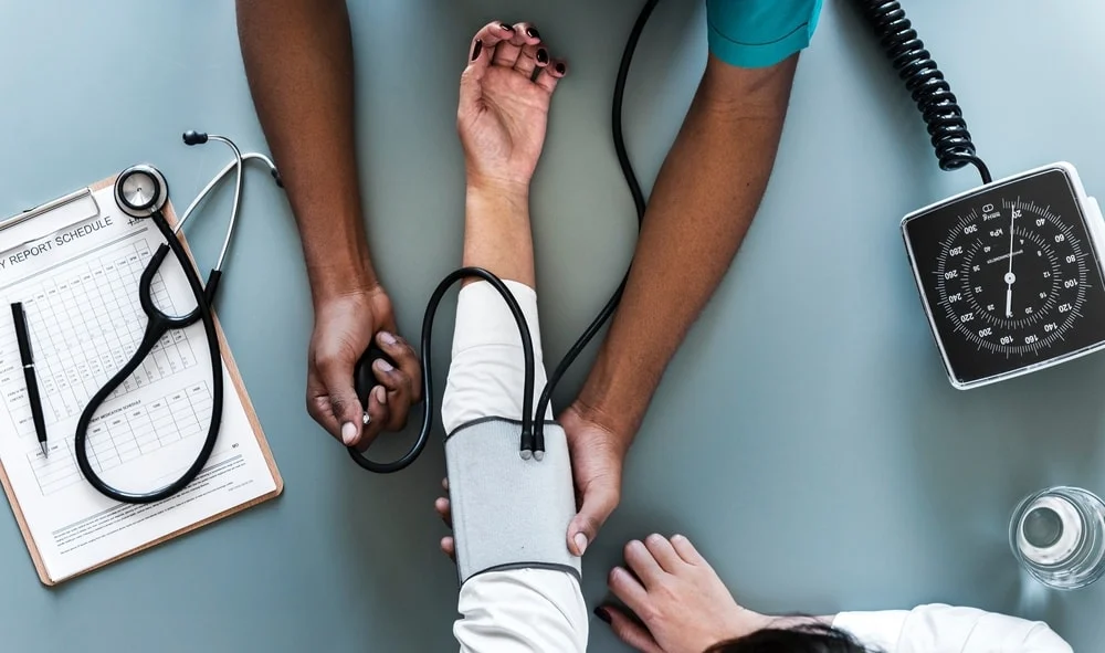 Doctor's hand holding a patient's hand.