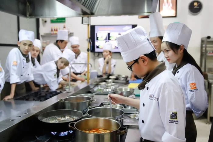 Culinary arts students cooking in the kitchen.