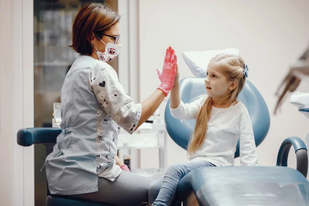 Pediatric dentist with a child patient.