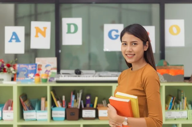 Early Childhood Education student holding books.