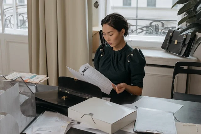 Asian female lawyer going through law papers.