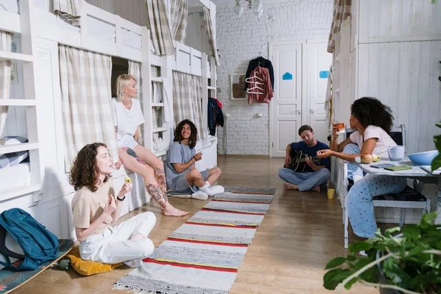 Students hanging out in their dorm room on campus.