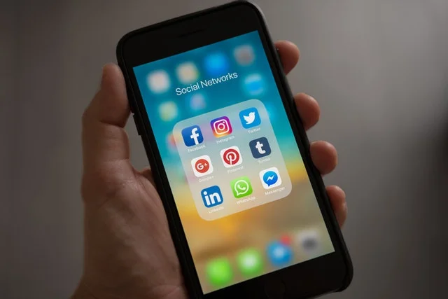 Phone screen with social media widgets.