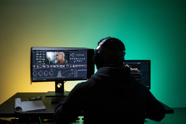 Man editing video using his computer.