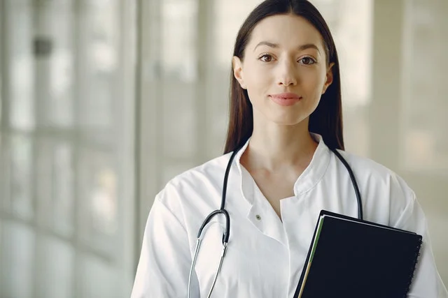 Medical student in white robe.