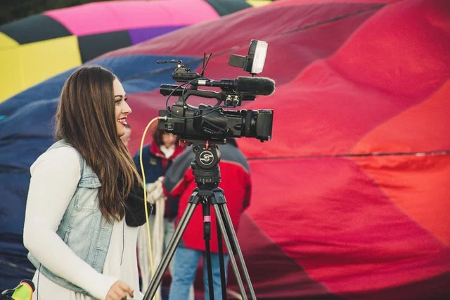 Mass communication student using a video camera.