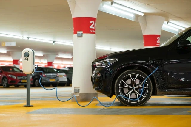 Electric car charging in a parking lot.