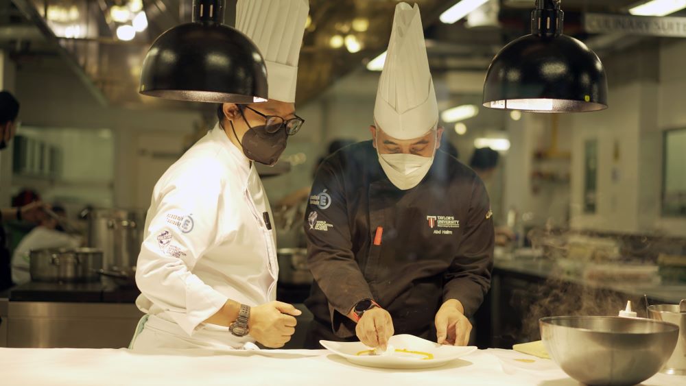  Chef Abd Halim Tumin garnishes plates for the main course.