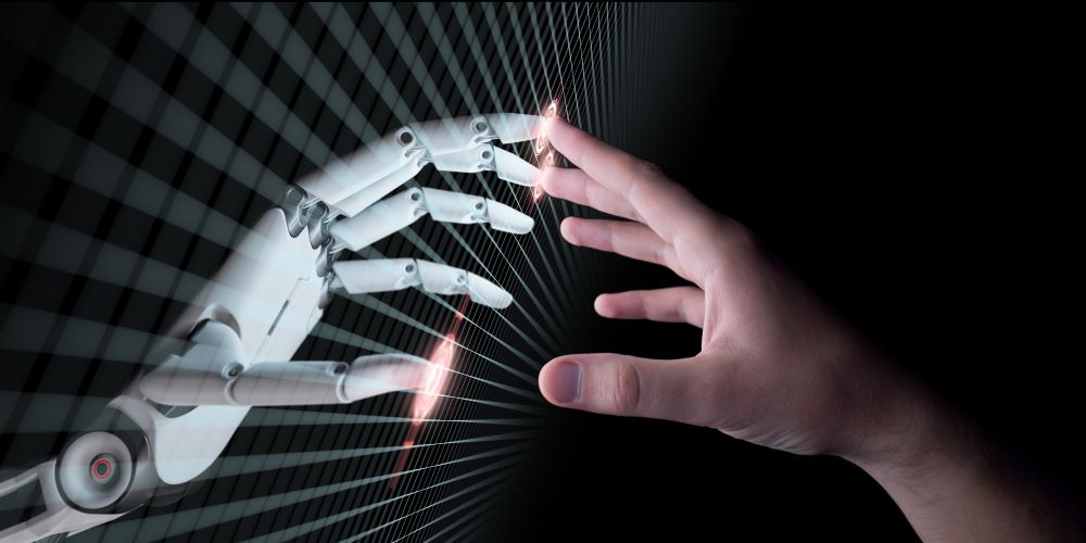 Robot and human hands touching at fingertips.