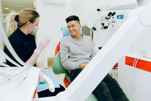 Dentist talking to patient.