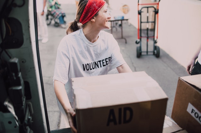 Female volunteer moving boxes after SPM.