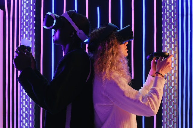 Man and woman wearing VR headsets.