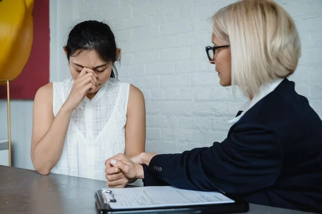 Psychologist consoling a sad patient.