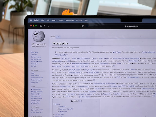 Wikipedia page on laptop screen.