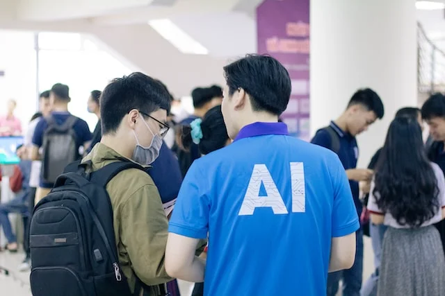 Man in blue tshirt in a crowd.